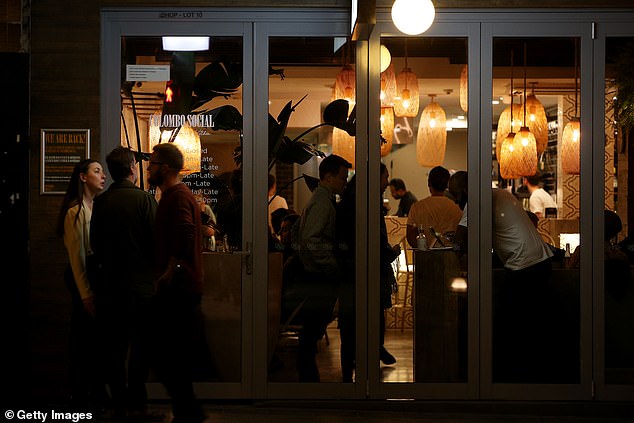 A bustling restaurant is seen in Sydney's Newtown on Friday night as restrictions continued to ease (pictured)