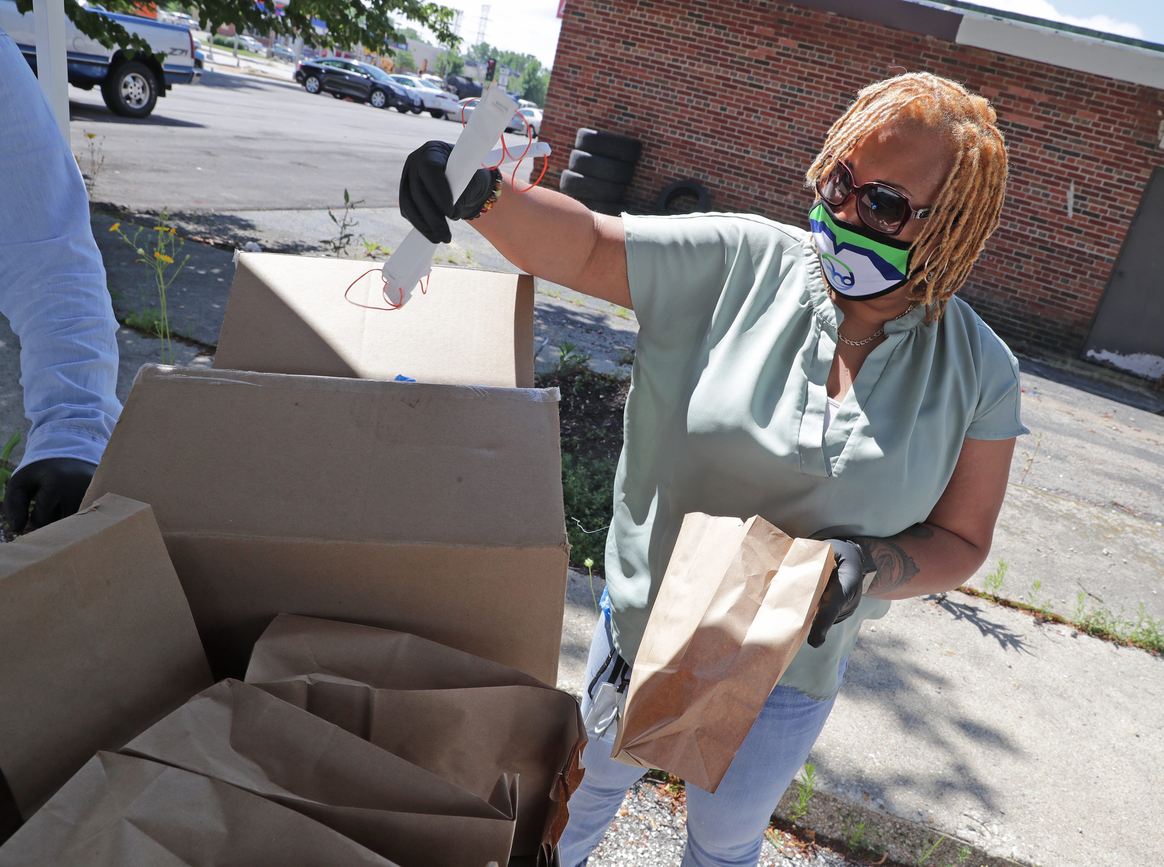 Erica Swan, with the Milwaukee Health Department, prepares bags with face masks before handing them out at the City Of Milwaukee Health Department-Northwest Health Center at 7630 W. Mill Road Milwaukee on July 16.