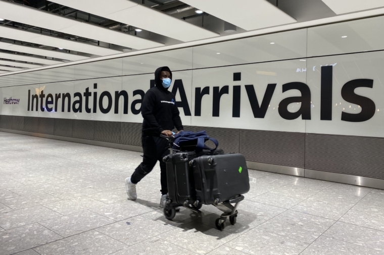 A passenger pushes a trolley through the Arrival Hall of Terminal 5 at London's Heathrow Airport after arriving into the UK following the suspension of the travel corridors. Passengers arriving from anywhere outside the UK, Ireland, the Channel Islands or the Isle of Man must have proof of a negative coronavirus test and self-isolate for 10 days. Picture date: Monday January 18, 2021. PA Photo. The Prime Minister said the measures were being introduced in order to protect the UK against new coronavirus variants from abroad. See PA story HEALTH Coronavirus. Photo credit should read: Kirsty O'Connor/PA Wire