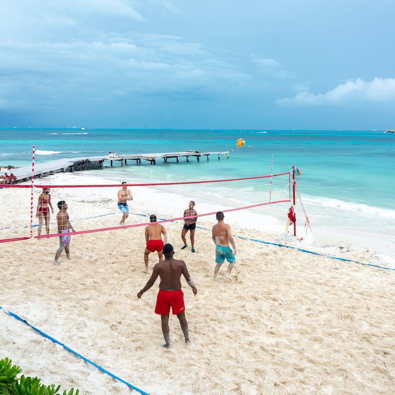 Tourists playing volleyball on the beach in all inclusive hotel in Cancun, Mexico