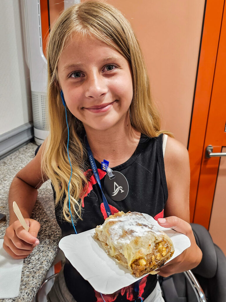 Young girl eating apple strudel