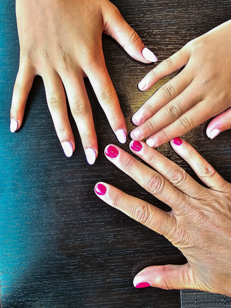 Three hands with nail polish