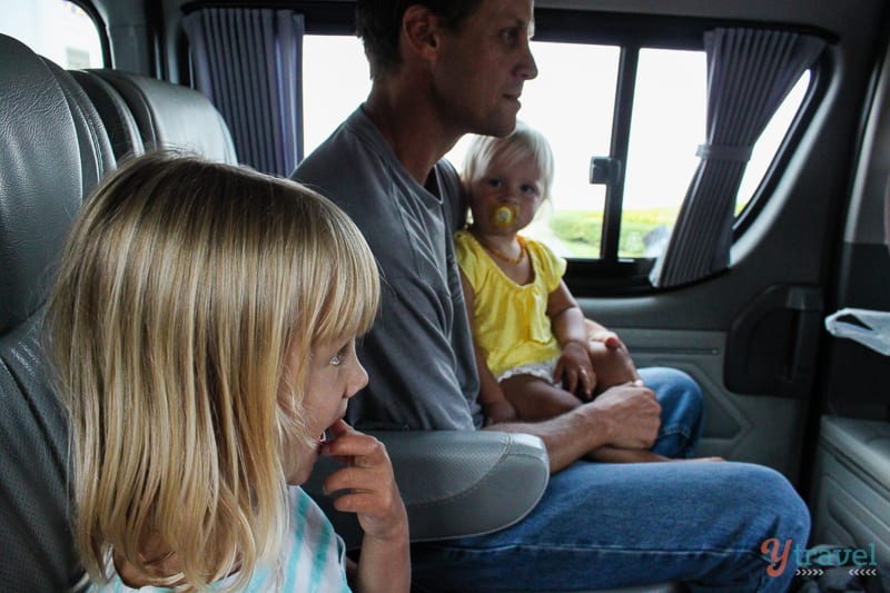 man and two kids in bus