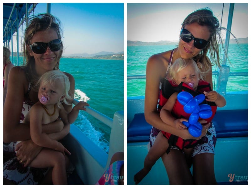 mum holding toddler on boat